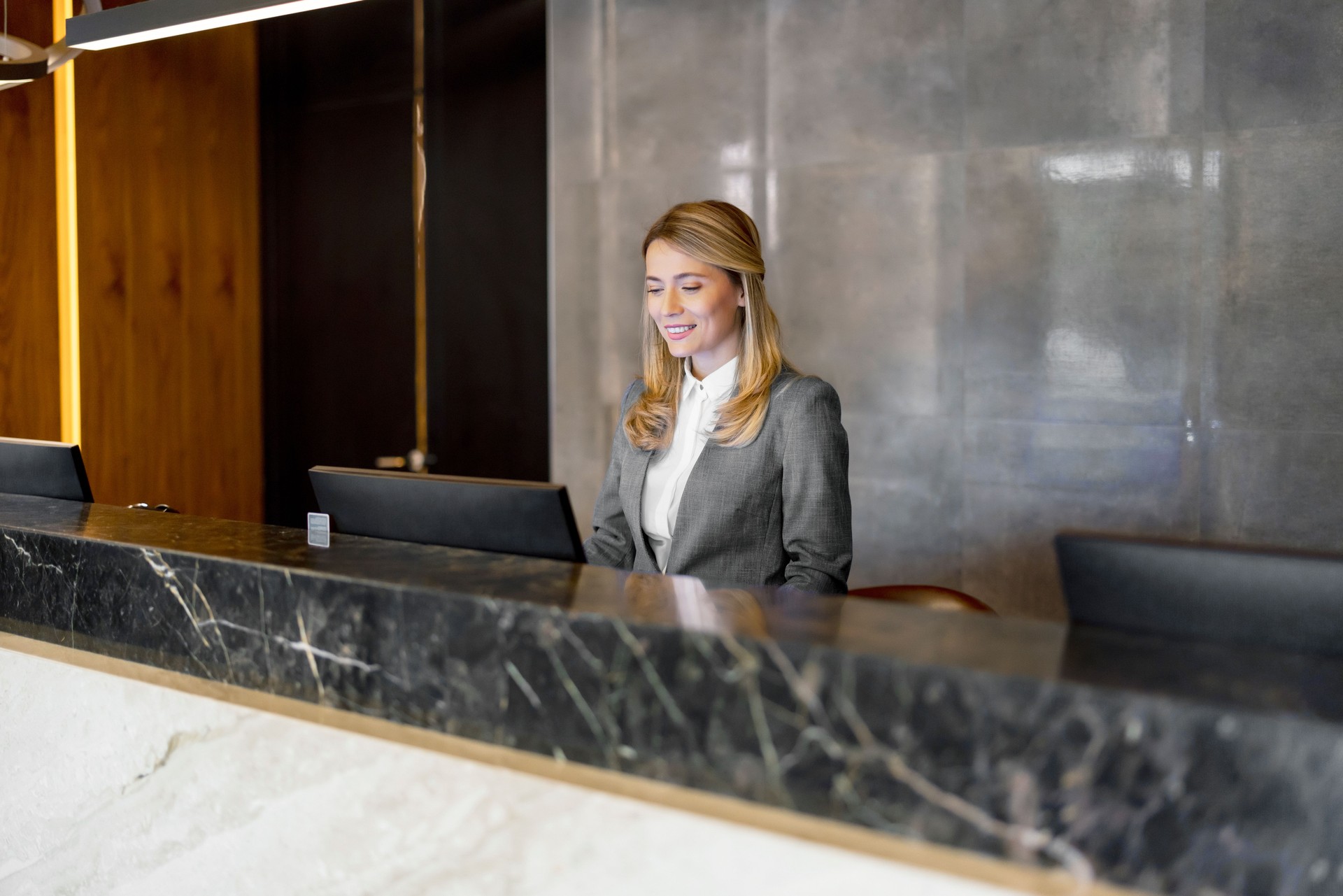 Female receptionist working at hotel counter